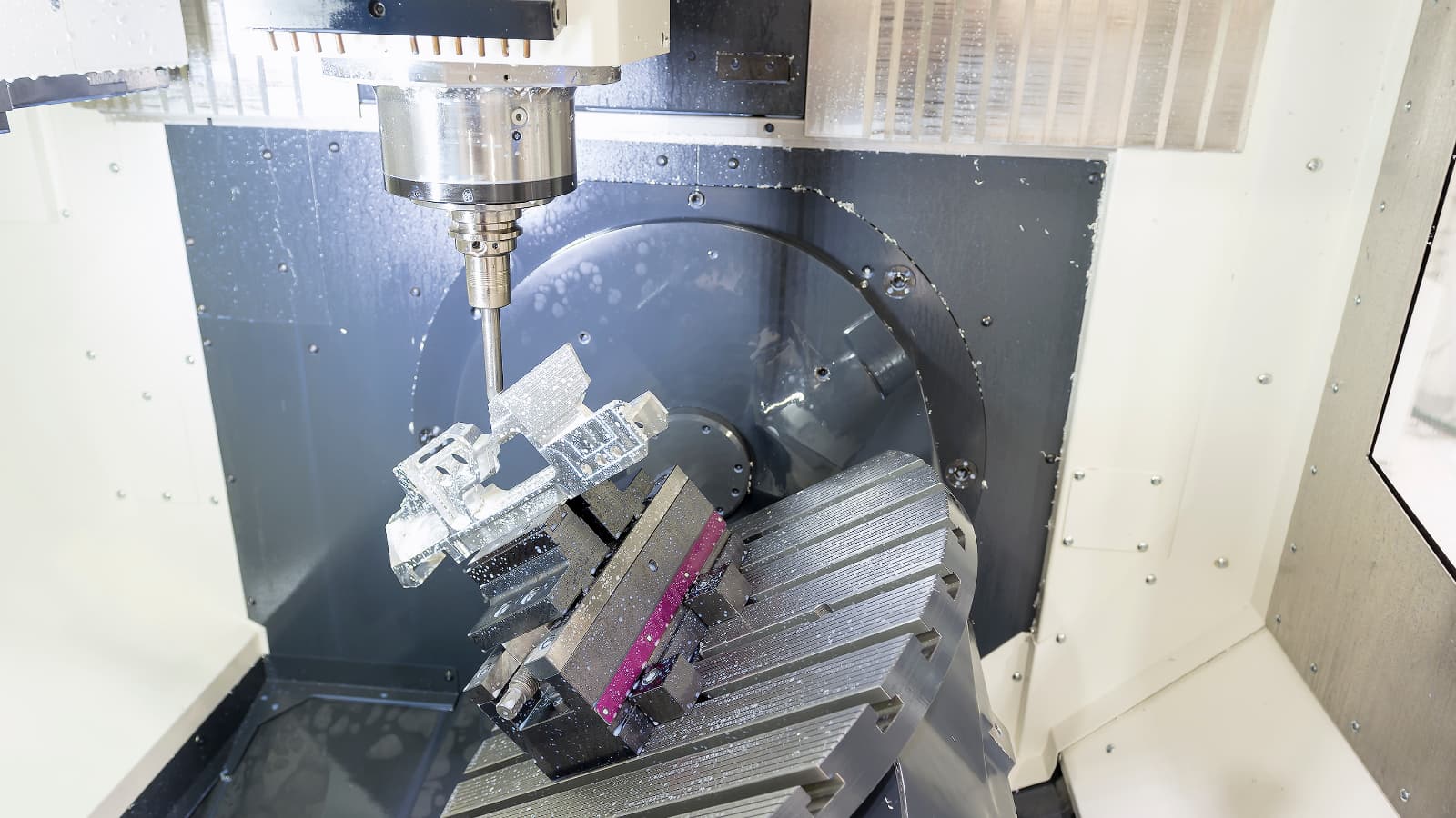 Five axis machining tool and tilted rotary workholding setup