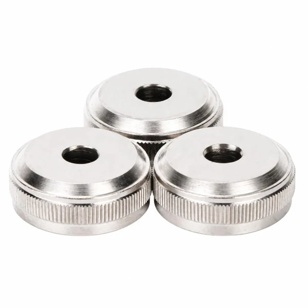 Three silver colored metal knobs with textured edges and central holes